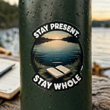 Sticker with 'Stay Present, Stay Whole' text on a green bottle with a scenic background.